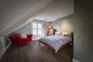 full height plantation shutters in white installed in a bed room in Southampton by The Great Shutter Co.